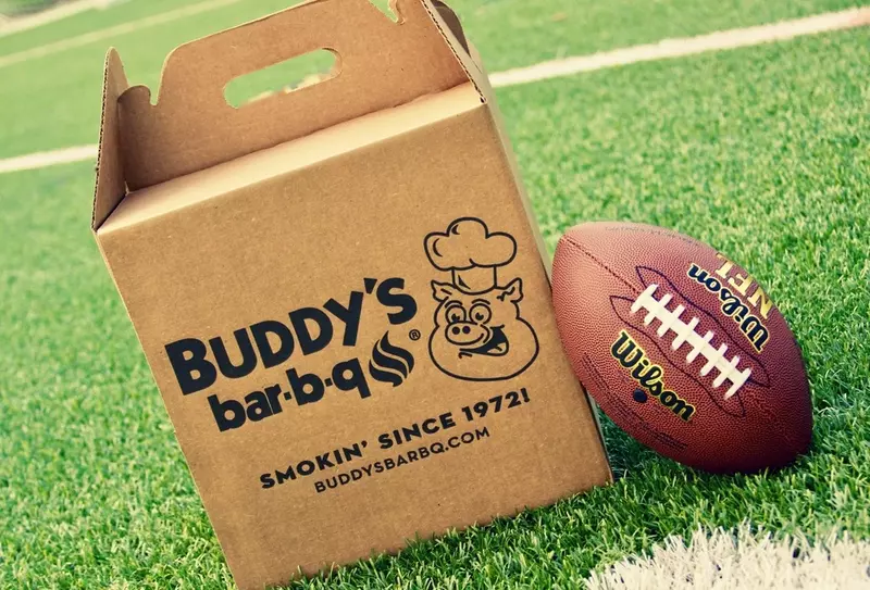 Buddy's bar-b-q catering box on football field next to football