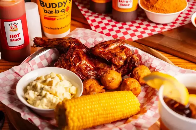 Half chicken meal with potato salad, corn, hush puppies